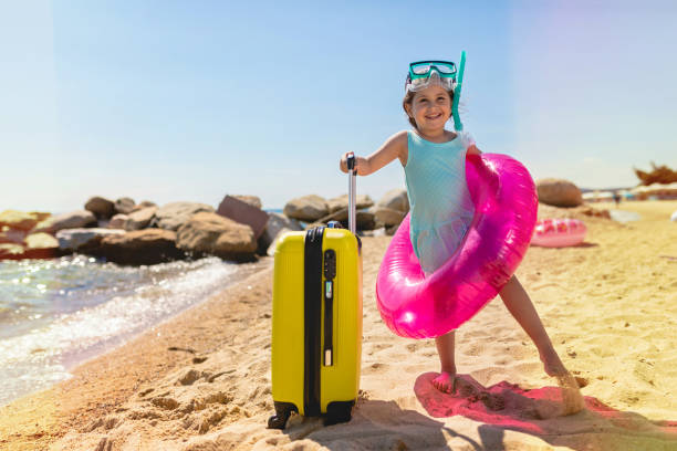 istock Girl holding vacation equipment 1162029563