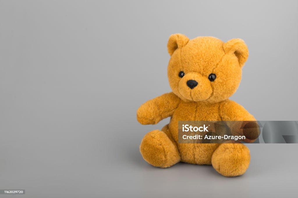 Teddy bear on grey background copyspace Childhood Stock Photo