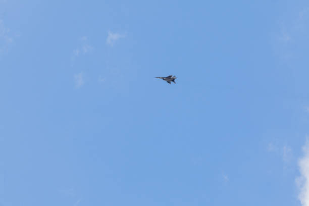 istock Military fighter in the blue sky with white clouds 1162035692
