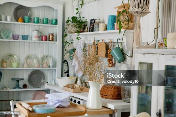 Stylish And Sunny Interior Of Kitchen Space With Small Wooden Table At The Photo Studio Scandinavian Room Decor With Kitchen Accessories Stock Photo - Download Image Now