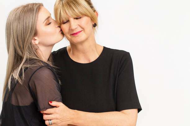 istock Daughter Kissing Mother on White Background 1162040100