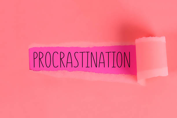 istock Procrastination, delay, urgency concept. Torn off piece paper opening inscription procrastination. 1162040741