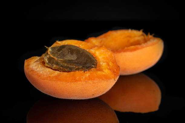 istock Fresh orange apricot isolated on black glass 1162041512