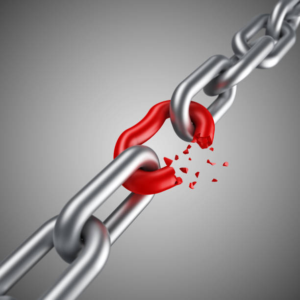 istock Steel chain breaking with unique red link 1162041577