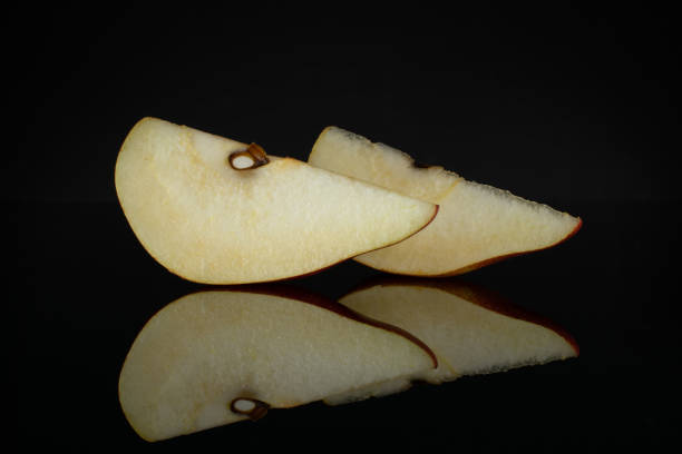 istock Anjou red pear isolated on black glass 1162041724