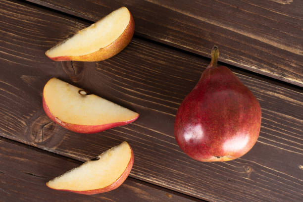 istock Anjou red pear on brown wood 1162041834