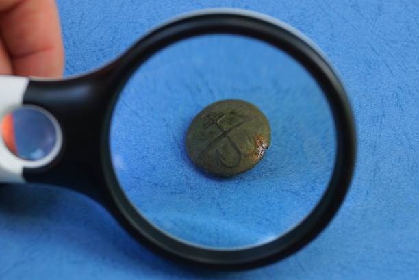 istock black magnifier enlarges old green brass button 1162042746