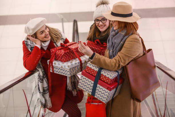 istock Mother and daughters with presents at the mall 1162045144