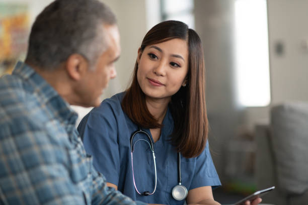 istock Young doctor with elderly patient 1162045212
