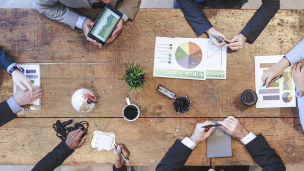 istock High Angle View of Business Team in Strategy Meeting 1162045357