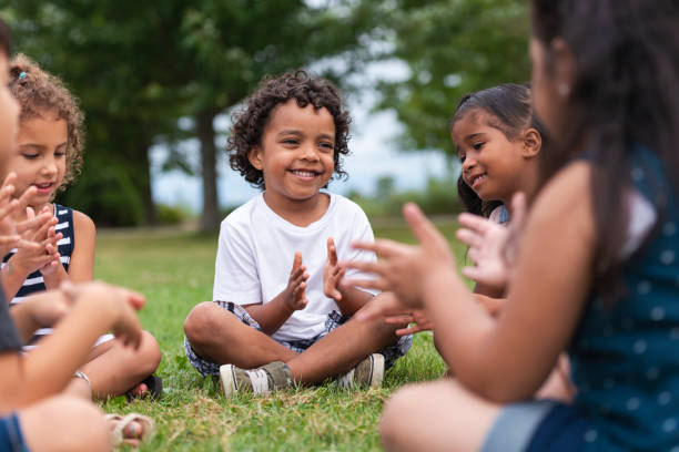 istock A Multi-Ethnic Group of Young Children are Clapping Outside 1162045562