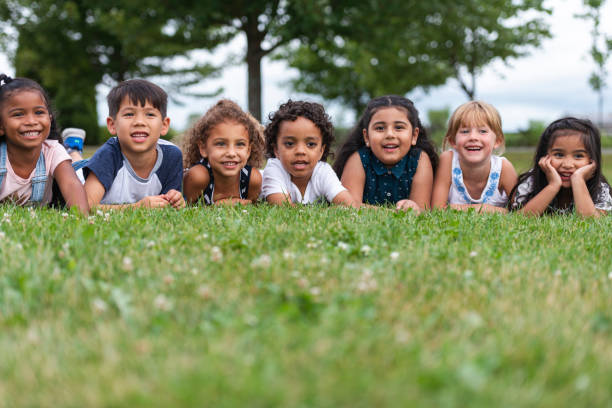 istock Multi-Ethnic Group of Kindergarten Kids Lying in the Grass 1162045563