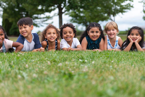 istock Multi-Ethnic Group of Kindergarten Kids Lying in the Grass 1162045565