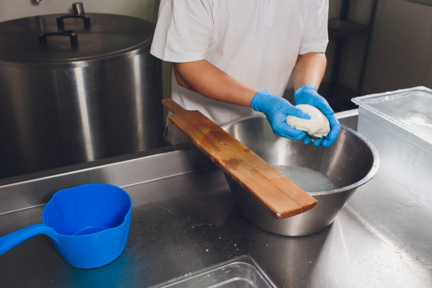 istock Traditional Cheese Making In A Small Company. Cheese Maker Hands Close-up Top View. 1162045784