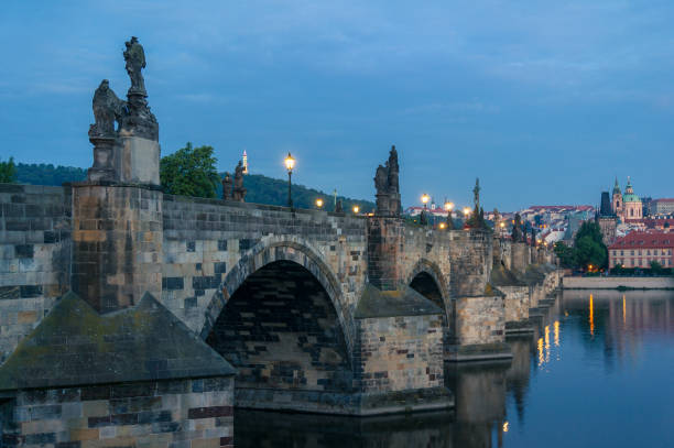 istock Charles bridge with stone sculptures and street lights 1162045993