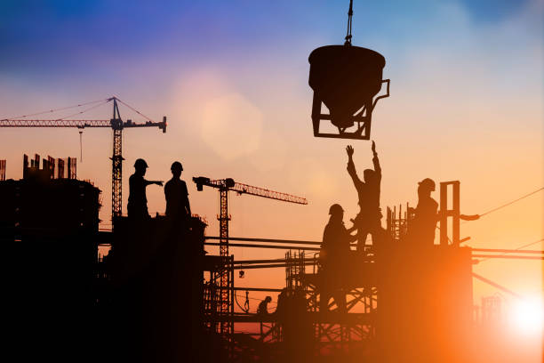 istock Silhouette of engineer and construction team working at site over blurred background for industry background with Light fair.Create from multiple reference images together 1162046062