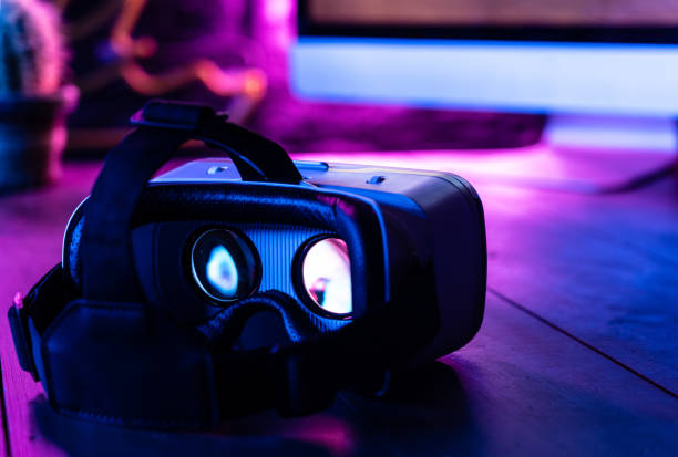 istock 3d 360 vr headset glasses goggles on computer work space table desk in futuristic purple neon light, virtual augmented ar reality modern digital innovation mobile technology experience concept 1162046205
