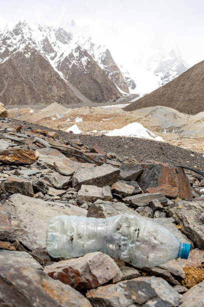 istock Garbage scattered over snowy mountain. Let's save the planet and recycle the excess garbage. 1162053406