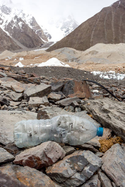 istock Garbage scattered over snowy mountain. Let's save the planet and recycle the excess garbage. 1162054025