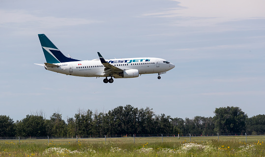 A WestJet Airlines Boeing 737, with identification C-FWSO, landing at Edmonton International Airport. Taken on July 14, 2019