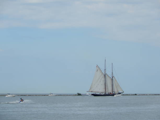 istock White rigged schooner sailing on the horizon 1162055364