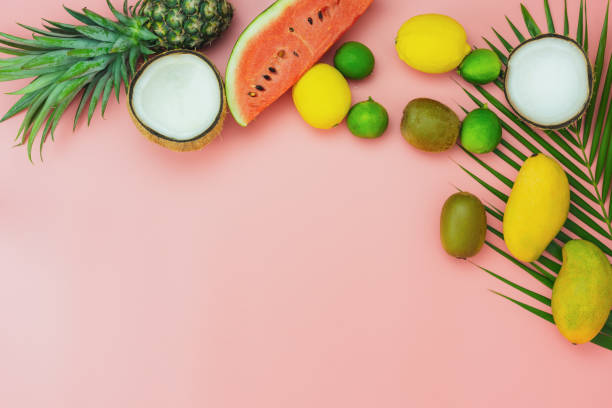 istock Table top view fruit tropical with spring summer holiday & vacation  background concept.flat lay arrangement sliced various watermelon pineapple kiwi mango lemon and lime coconut on pink paper. 1162056200