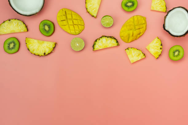 istock Table top view fruit tropical with spring summer holiday & vacation  background concept.Arrangement sliced various pineapple kiwi mango lemon and lime coconut on  pink paper.flat lay & copy space. 1162056204