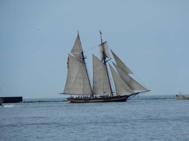istock White sailed tall ship sailing past quay 1162056357