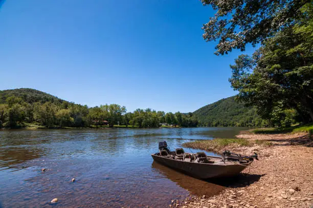 Photo of A boat tied up to the shoreline of the Allegheny river in Warren County, Pennsylvania, USA