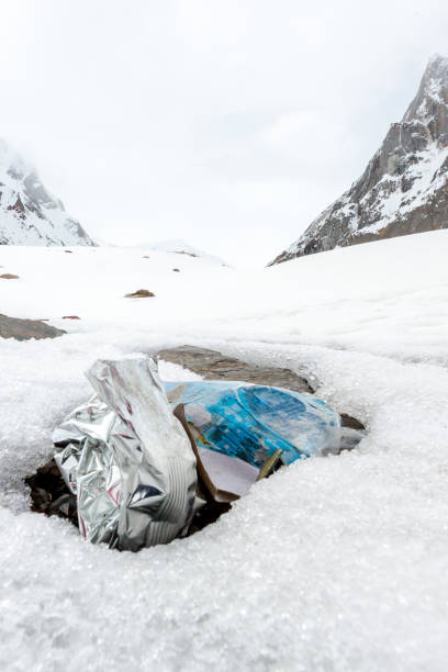 istock Garbage scattered over snowy mountain. Let's save the planet and recycle the excess garbage. 1162058587