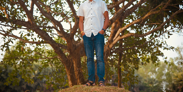 Man in a blue jeans standing in a place unique stock photo