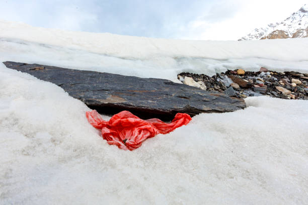 istock Garbage scattered over snowy mountain. Let's save the planet and recycle the excess garbage. 1162061128