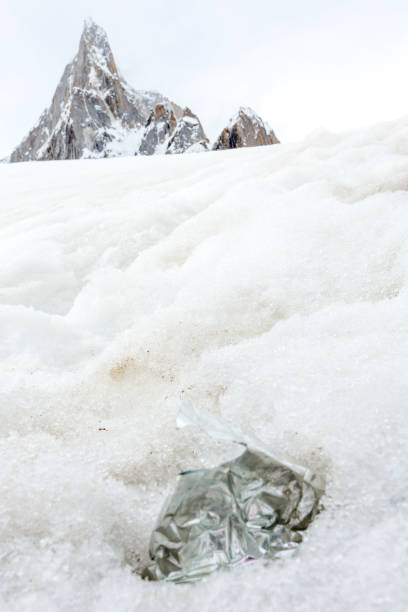 istock Garbage scattered over snowy mountain. Let's save the planet and recycle the excess garbage. 1162063296
