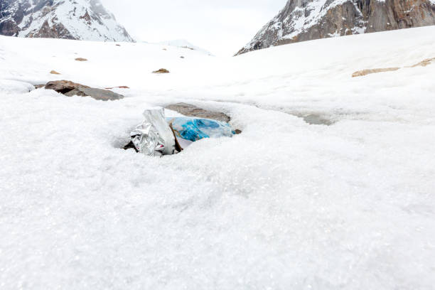 istock Garbage scattered over snowy mountain. Let's save the planet and recycle the excess garbage. 1162063372