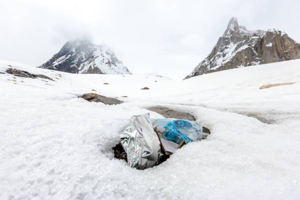 istock Garbage scattered over snowy mountain. Let's save the planet and recycle the excess garbage. 1162063938