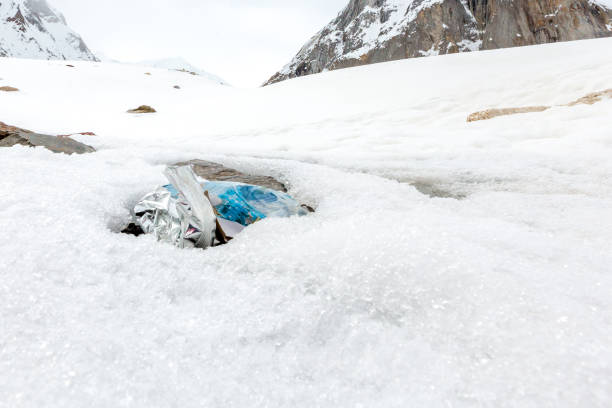 istock Garbage scattered over snowy mountain. Let's save the planet and recycle the excess garbage. 1162063962