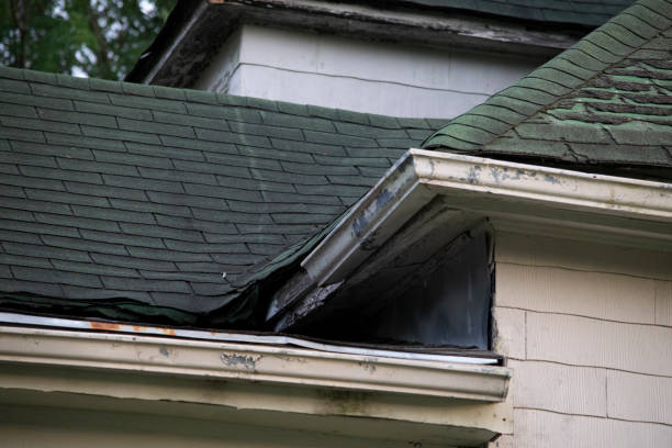 istock Damaged and old roofing shingles and gutter system on a house 1162064329