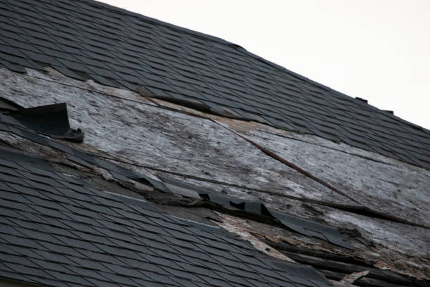 istock Damaged and old roofing shingles and gutter system on a house 1162064334