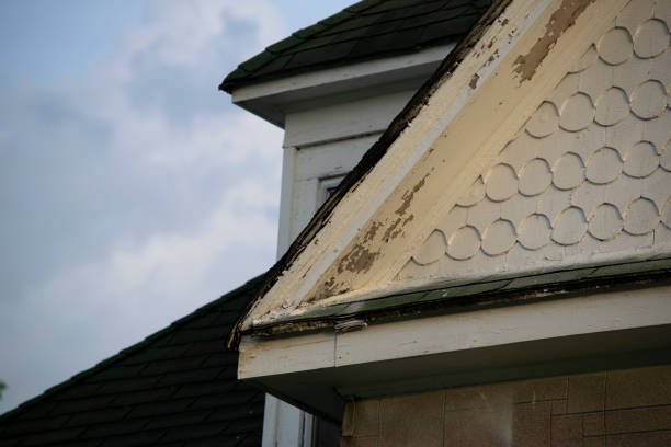 istock Damaged and old roofing shingles and paint on a house 1162064385
