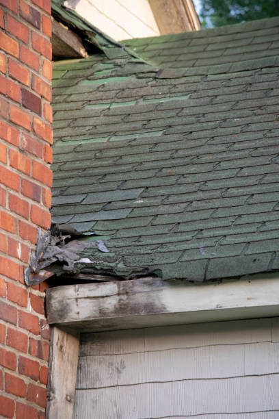 istock Damaged and old roofing shingles,chimney, and gutter system on a house 1162064396