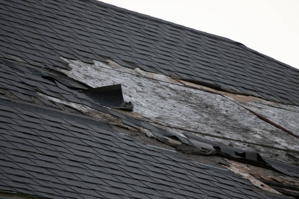 istock Damaged and old roofing shingles and gutter system on a house 1162064398