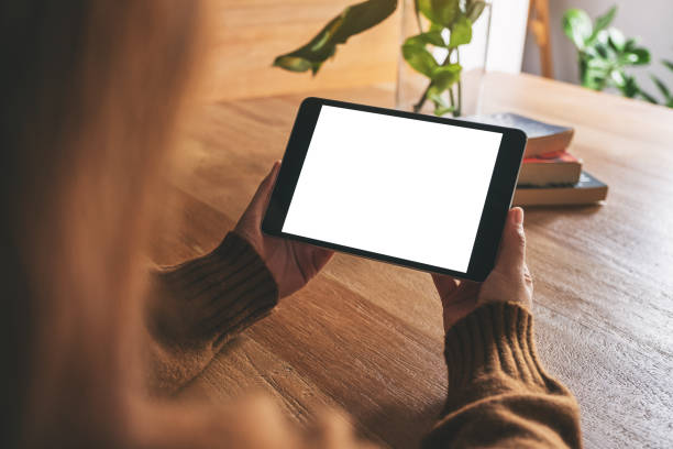 istock a woman holding and using black tablet pc with blank white desktop screen 1162065182