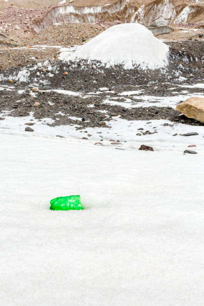 istock Garbage scattered over snowy mountain. Let's save the planet and recycle the excess garbage. 1162065408