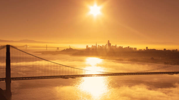 san francisco golden gate bridge warm sunrise - san francisco county bridge california fog imagens e fotografias de stock