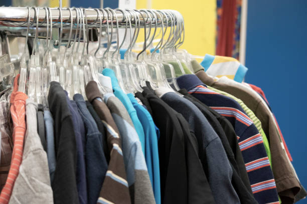 istock Clothing hanging on a rack in a store 1162066315
