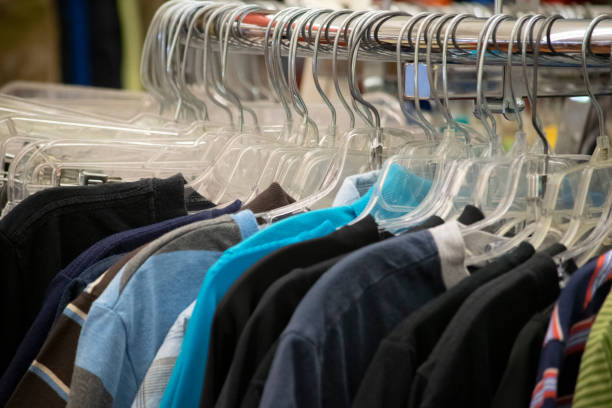 istock Clothing hanging on a rack in a store 1162066316