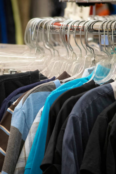 istock Clothing hanging on a rack in a store 1162066318