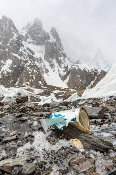 istock Garbage scattered over snowy mountain. Let's save the planet and recycle the excess garbage. 1162067374