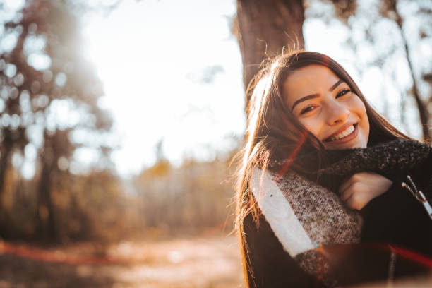 Beautiful young woman enjoying autumn day in nature