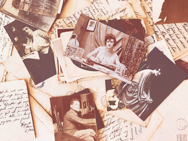 istock Vintage photos and letters scattered over table 1162078705